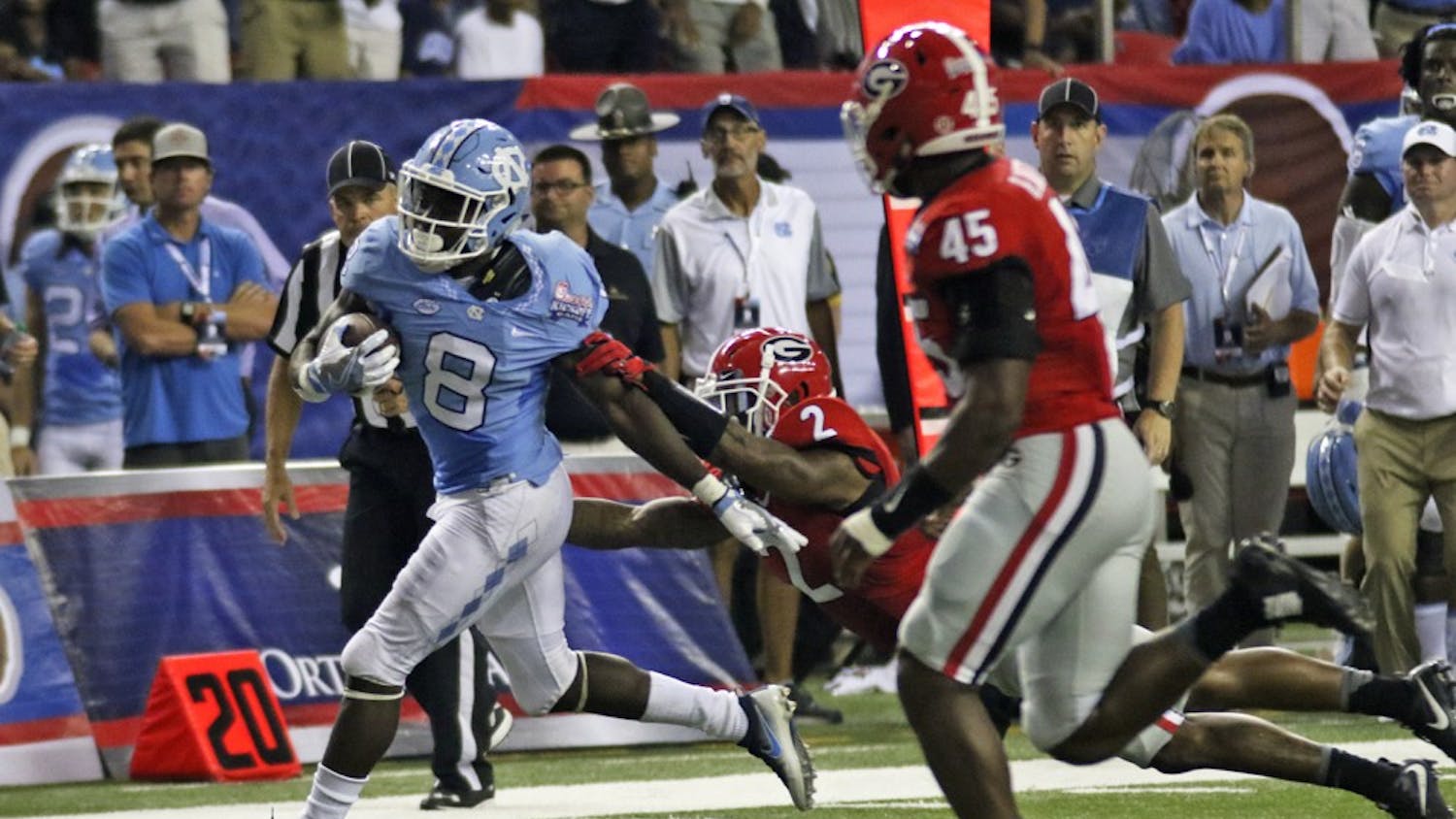 UNC running back T.J. Logan (8) sheds a tackle from Georgia defensive back Maurice Smith (2) en route to his first touch down of the day. The Tar Heels fell to the Bulldogs 33-24 on Saturday in Atlanta.