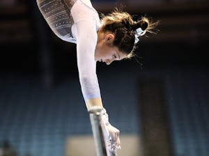 First-year Julia Knower competes on uneven bars during UNC gymnastics' home meet at Carmichael Arena on Friday, Jan. 28, 2022. Knower scored a 9.800.