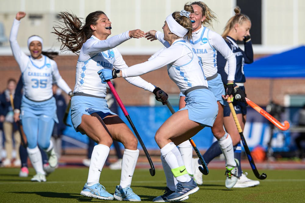 <p>UNC junior back Ciana Riccardo (8) and senior forward Erin Matson (1) celebrate a goal in the second quarter of the field hockey game against No. 6 Penn State on Friday, Nov. 18, 2022, at the George J. Sherman Sports Complex in Storrs, Conn. UNC beat Penn State 3-0.</p>
