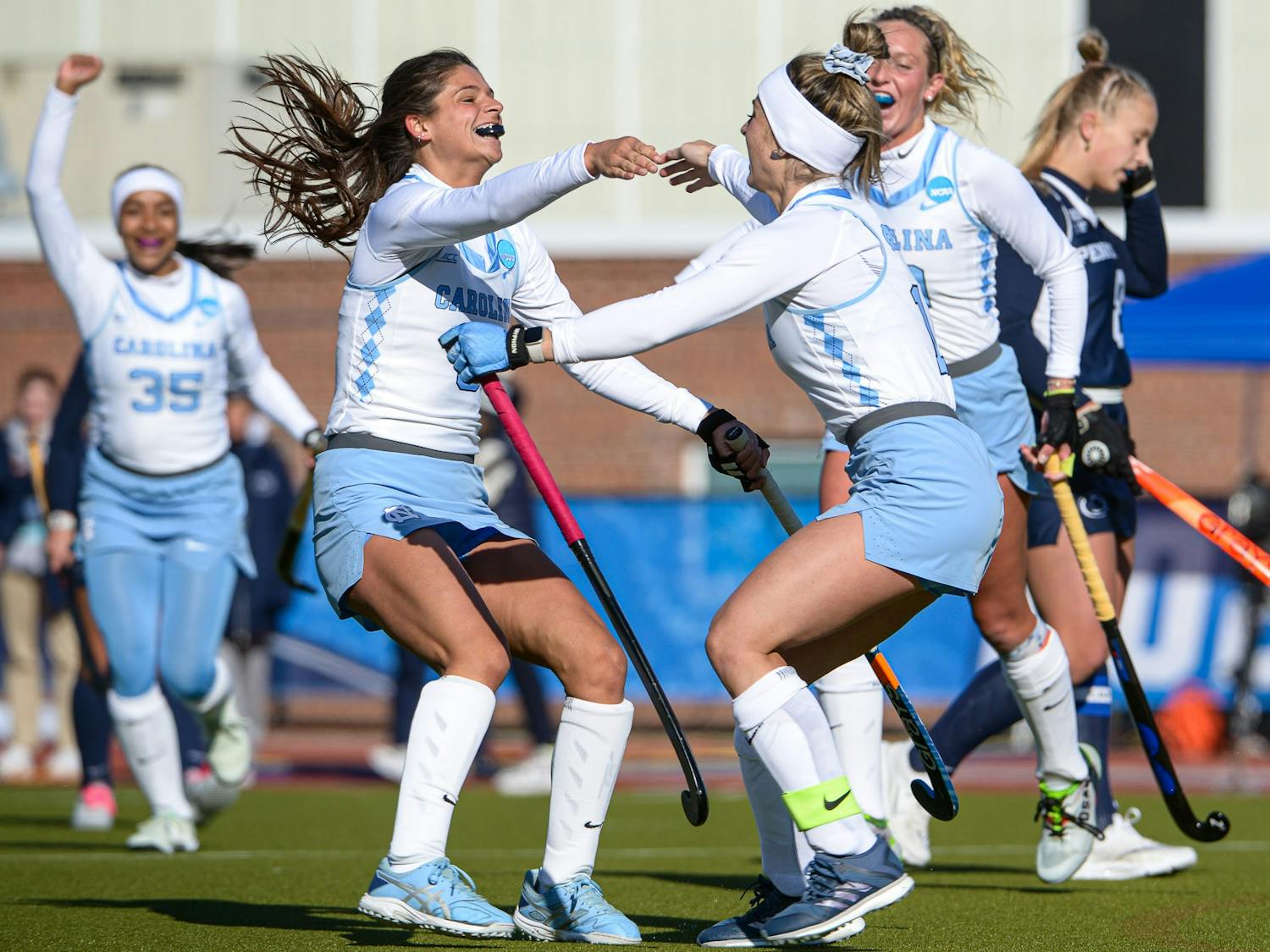 UNC junior back Ciana Riccardo (8) and senior forward Erin Matson (1) celebrate a goal in the second quarter of the field hockey game against No. 6 Penn State on Friday, Nov. 18, 2022, at the George J. Sherman Sports Complex in Storrs, Conn. UNC beat Penn State 3-0.
