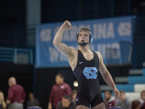 UNC junior A. C. Headlee celebrates after winning his bout against his Virginia Tech Opponent (4-2) in Carmichael Arena on Friday, Feb. 8, 2019. UNC won the overall competition against Virginia Tech 18-14.