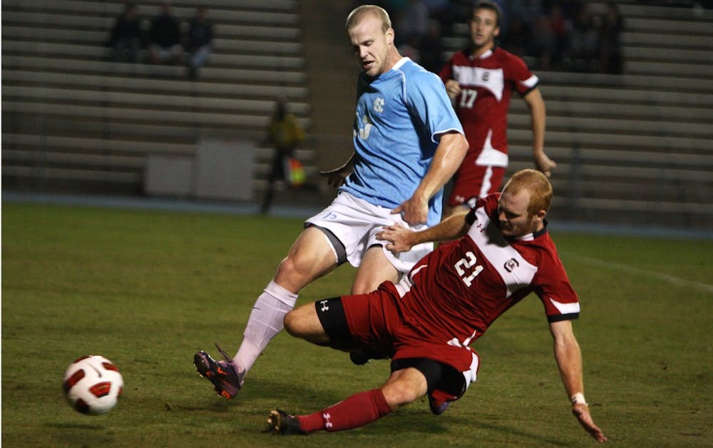 Redshirt freshman Josh Rice is taken down by South Carolina defender Danny Cates. The match featured seven yellow cards, four by South Carolina, and two red cards that were split between the two squads.