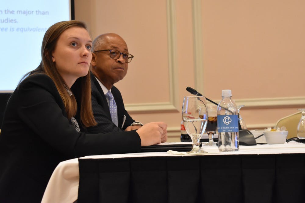 Student Body President Savannah Putnam (left) and Board of Trustees member William Keyes (right) listen to a presentation about lowering the maximum credit hours for a number of degree programs during a University Affairs committee meeting in the Carolina Inn on Wednesday, Nov. 14, 2018. 