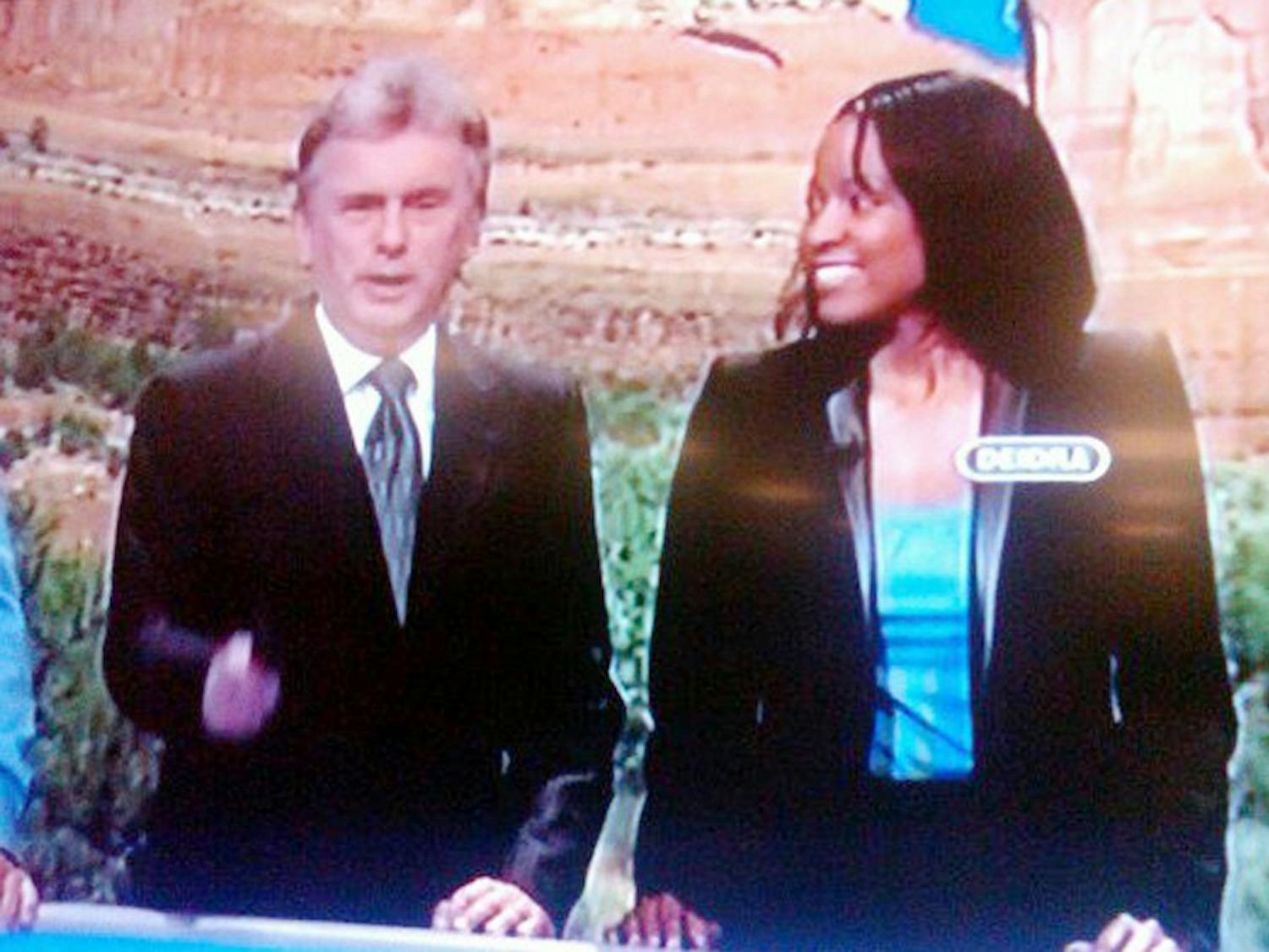 	Deidra Debnam (right) talks with Pat Sajak, the host of Wheel of Fortune, as a contestant on the show. Photo Courtesy of Deidra Debnam