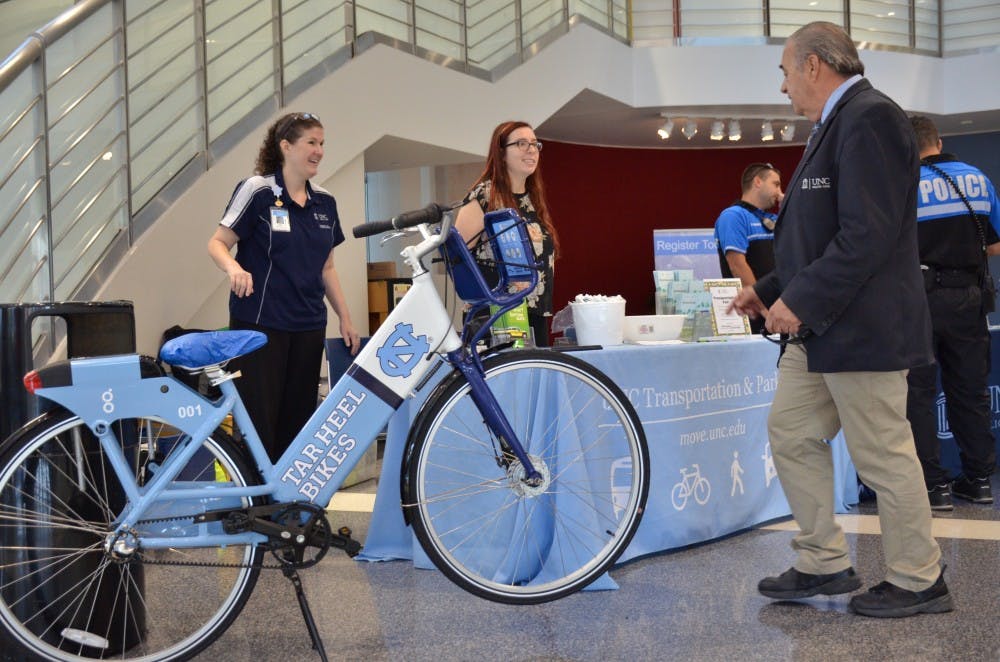 Carolyn Caggia, the Transportation Outreach Coordinator of UNC Transportation & Parking, presents information at a booth in the UNC Children's Hospital lobby.