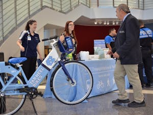 Carolyn Caggia, the Transportation Outreach Coordinator of UNC Transportation & Parking, presents information at a booth in the UNC Children's Hospital lobby.