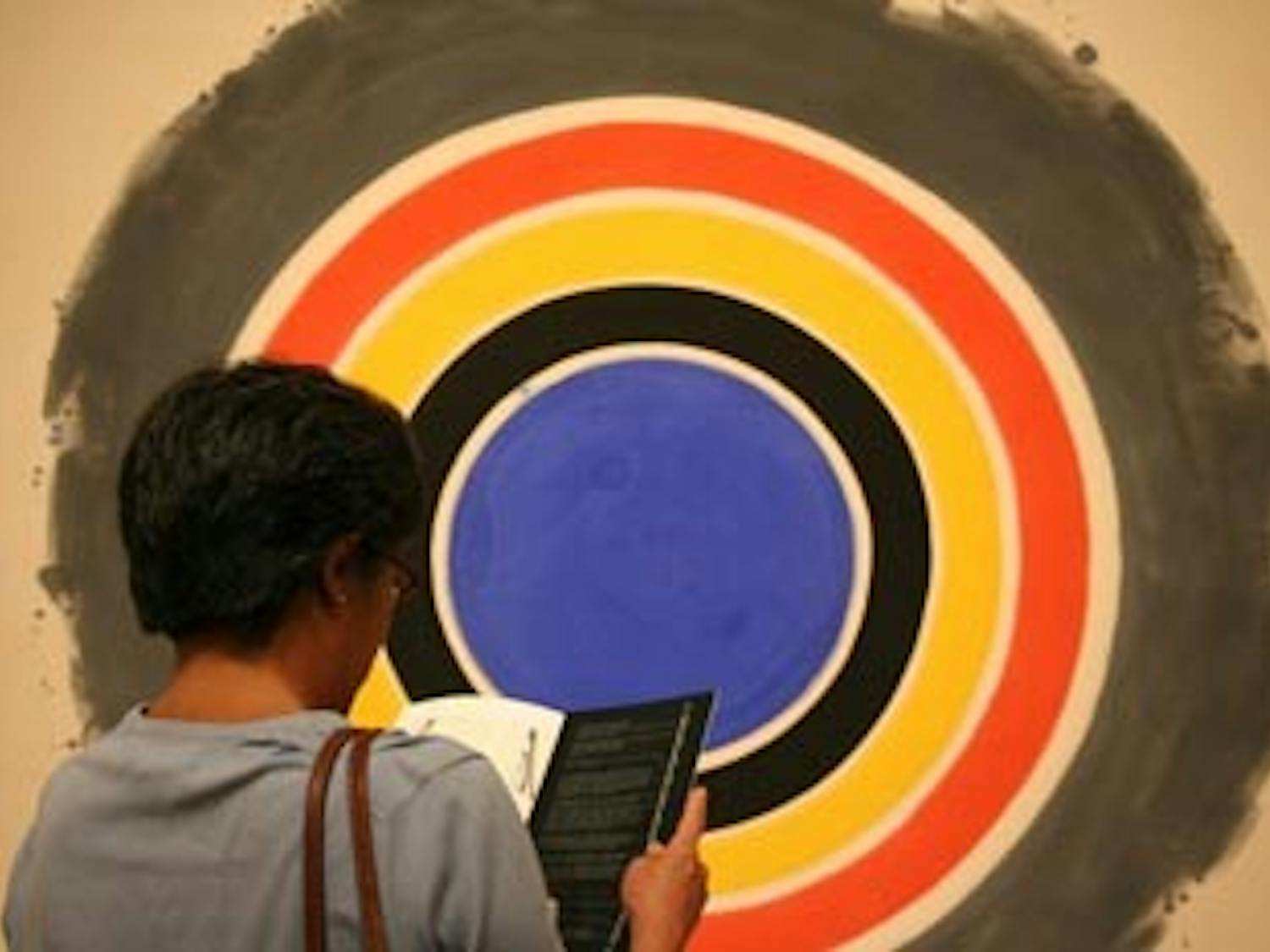 Anna Wu of Durham views the Kenneth Noland piece, "That," at the opening of the Circa 1958 exhibition at the Ackland.