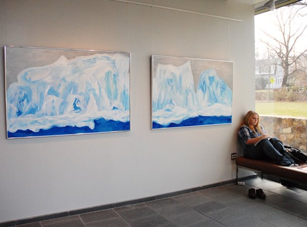 Freshmen Parker Jackson studies Monday in the FedEx Global Education Center near a painting part of “Ice Counterpoint"