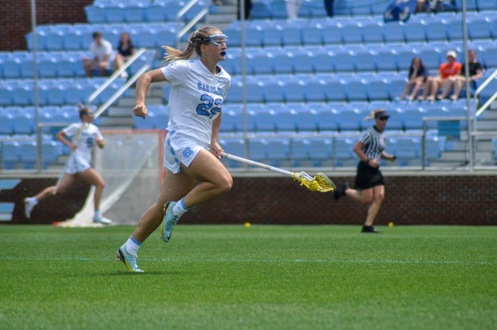 UNC freshman midfielder Ellie Traggio (22) runs down the field with possession of the ball during the women’s lacrosse game against Syracuse at Dorrance Field on Saturday, April 15, 2023. Syracuse defeated UNC 14-12.