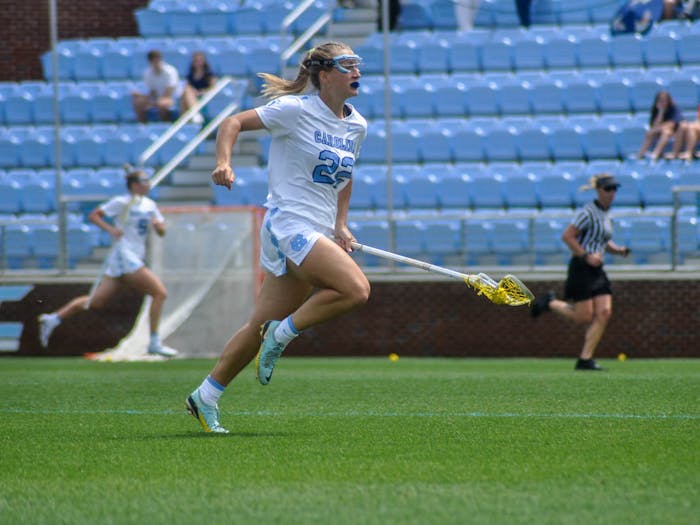 UNC freshman midfielder Ellie Traggio (22) runs down the field with possession of the ball during the women’s lacrosse game against Syracuse at Dorrance Field on Saturday, April 15, 2023. Syracuse defeated UNC 14-12.