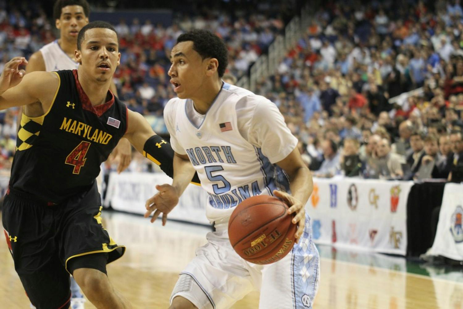 	Marcus Paige drives along the baseline past Maryland&#8217;s Seth Allen.