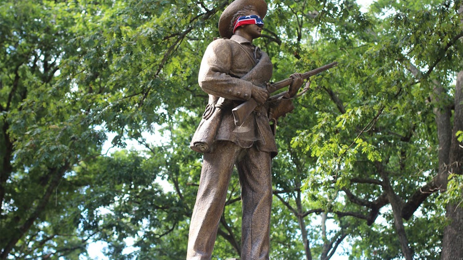 The Silent Sam statue in McCorkle Place is wrapped in a confederate flag one day in September of 2015.&nbsp;