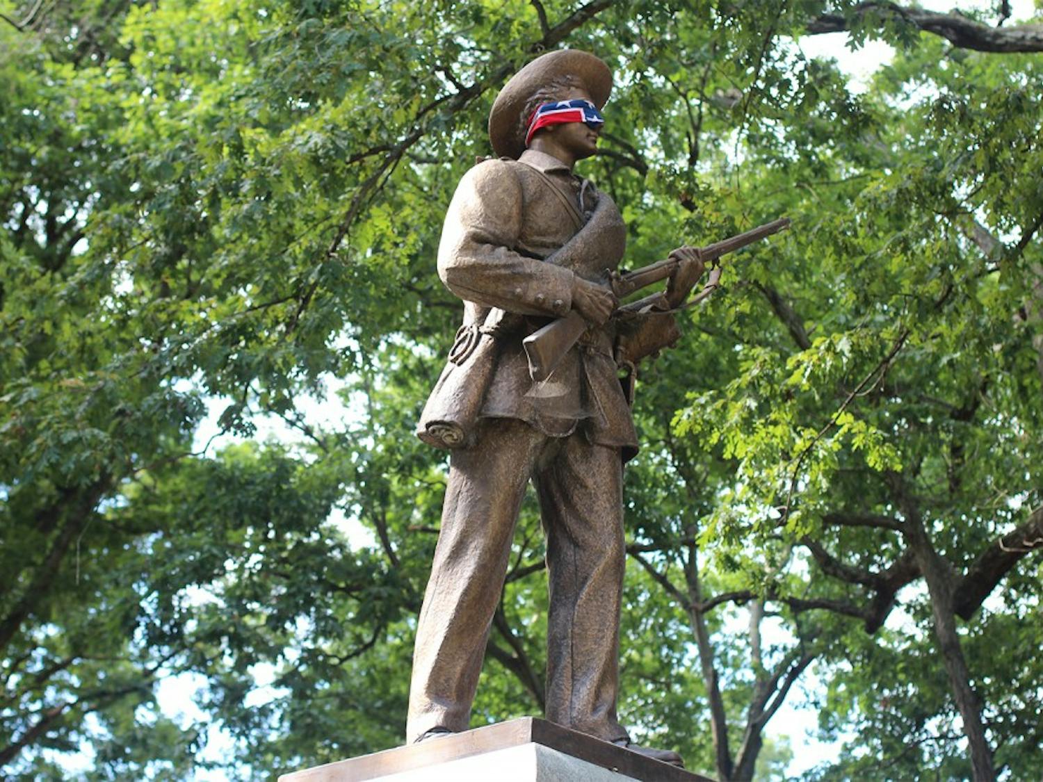 The Silent Sam statue in McCorkle Place is wrapped in a confederate flag one day in September of 2015.&nbsp;