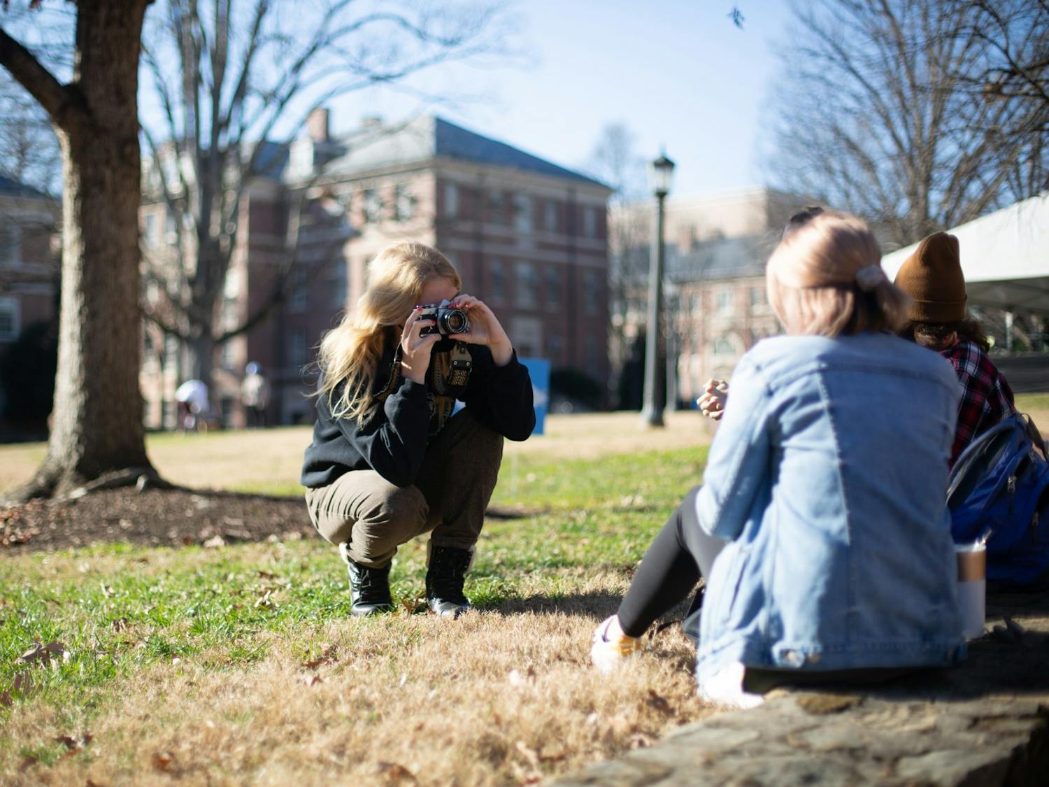 Sophomore advertising and public relations major Rainey Scarborough takes a photo of her friend, junior media and journalism major Claudia Benfield, in the Quad on Wednesday, Jan. 27, 2021.