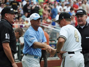 	Mike Fox shakes the hand of Vanderbilt’s head coach Tim Corbin. Vanderbilt would go on to knock UNC out of the College World Series. 