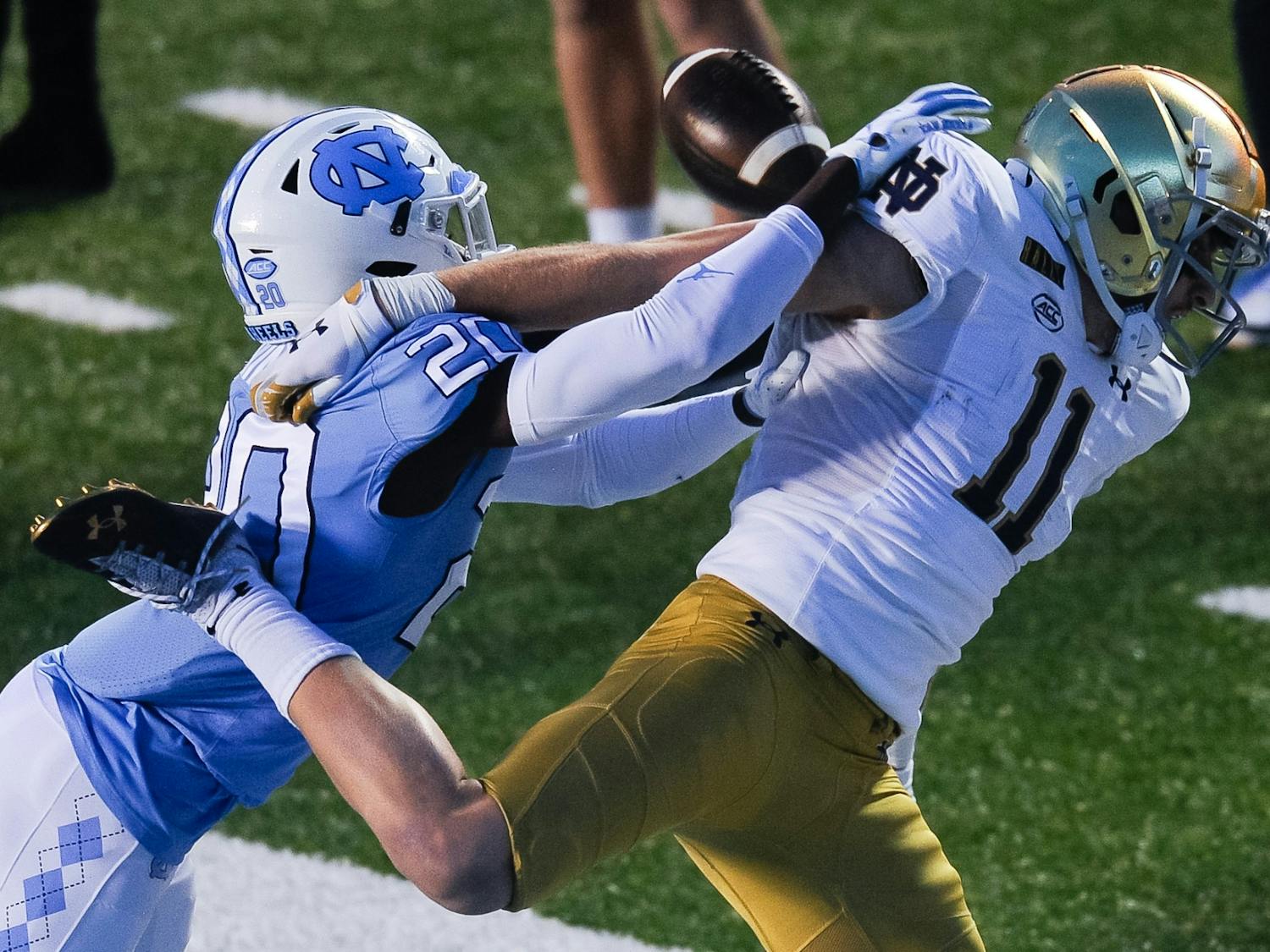 UNC's first year center back Tony Grimes (20) blocks a pass to Notre Dame's graduate wide receiver Ben Skowronek (11) during a game in Kenan Memorial Stadium on Friday, Nov. 27, 2020. Notre Dame beat UNC 31-17.