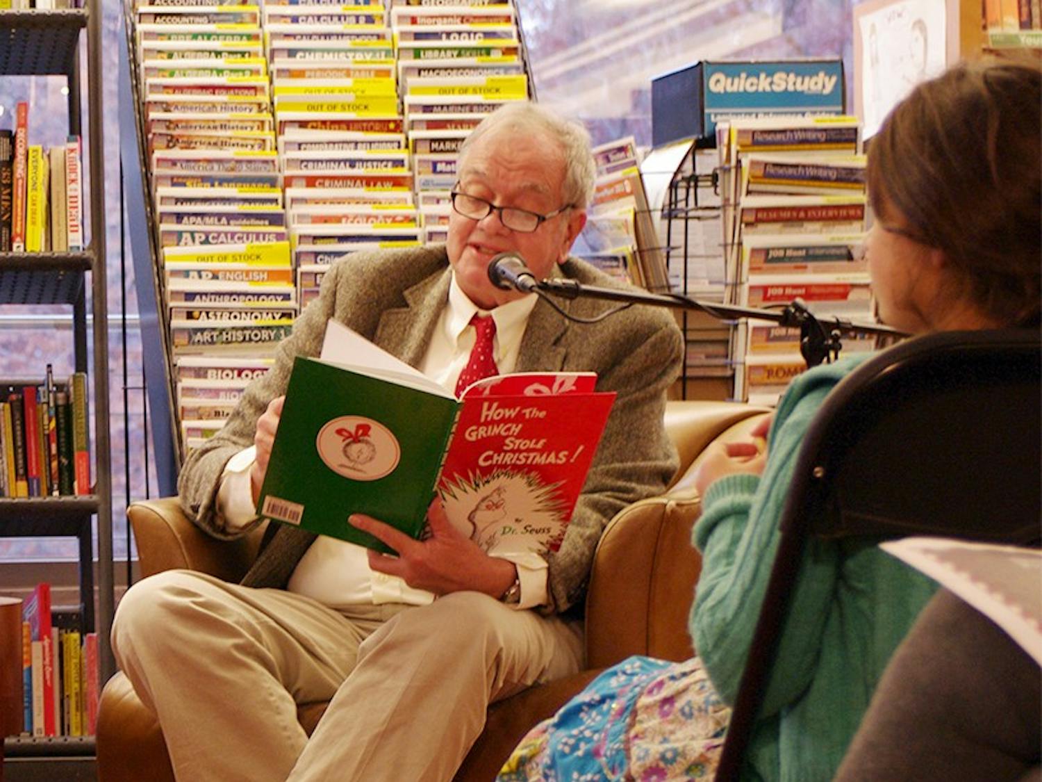 UNC Student Stores employee George Morgan (left) and Professor Tom Stumpf (right) read "How the Grinch Stole Christmas" in Latin and English at Bull's Head Bookshop's annual reading. 
