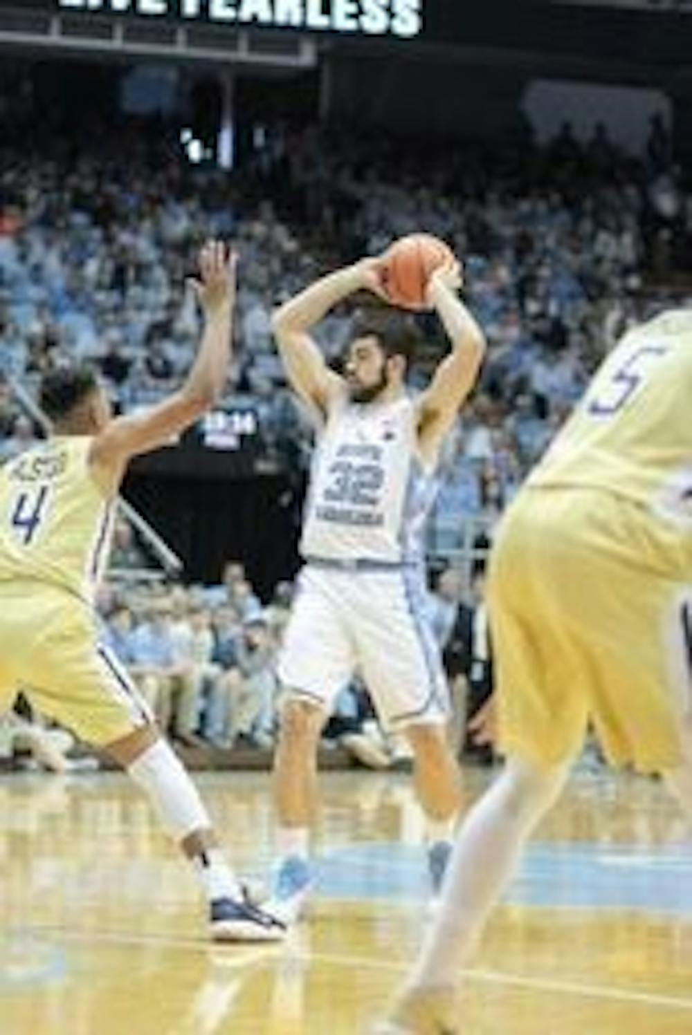 <p>Luke Maye (32) goes to pass the ball during the Georgia Tech game at the Dean Smith Center on Saturday.&nbsp;</p>