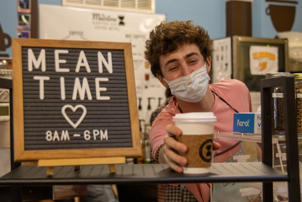 UNC junior environmental studies and business major Maxwell Lewin is a barista and chief sustainability officer at The Meantime Coffee Company, which operates in the lobby of the Campus Y. Lewin delivers a chai latte on Sept. 13.