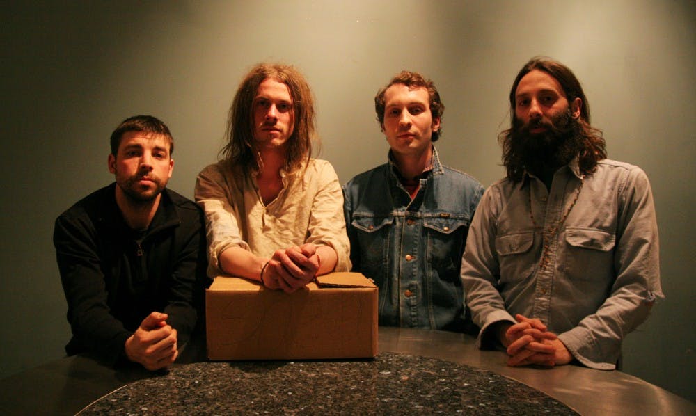 Josh Pope, Ryan Gustafson, Carter Gaj and James Wallace with a box containing their new album Drughorse One. DTH/Jordan Lawrence