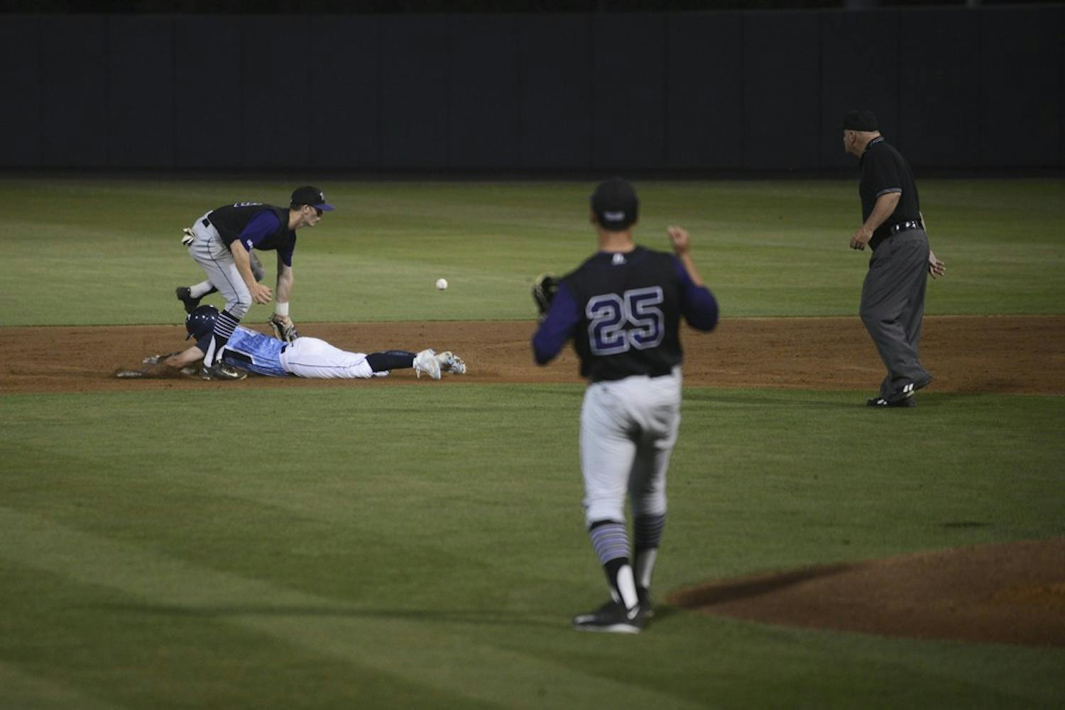 UNC sophomore Tyler Ramirez (14) safely steals second after knocking the ball lose in Tuesday's game against High Point.