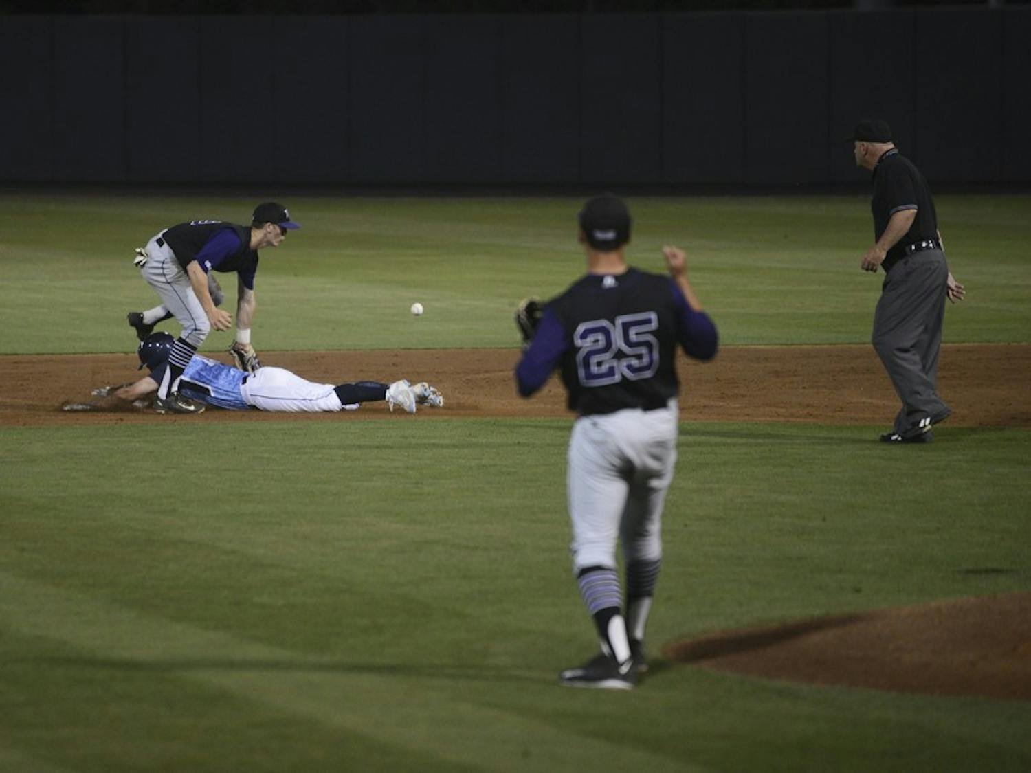 UNC sophomore Tyler Ramirez (14) safely steals second after knocking the ball lose in Tuesday's game against High Point.