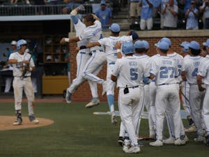 UNC baseball players celebrate after a big home run in the bottom of the ninth during the first round of the regional championships versus UNCW. UNC won 7-6. 