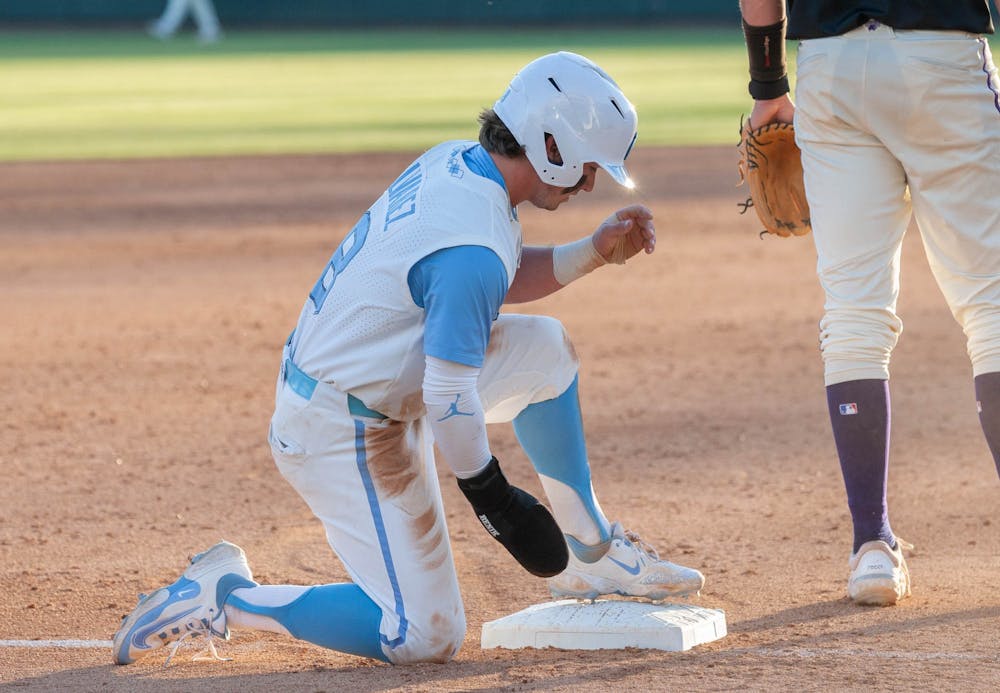 UNC Junior Infielder and Outfielder Patrick Alvarez (8) catches his breath after successfully sliding into third base in the March 7, 2023 game against Western Carolina University in Boshamer Stadium.