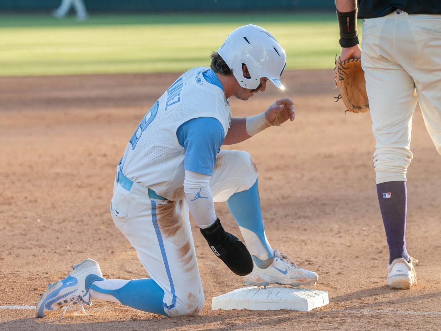 UNC Junior Infielder and Outfielder Patrick Alvarez (8) catches his breath after successfully sliding into third base in the March 7, 2023 game against Western Carolina University in Boshamer Stadium.