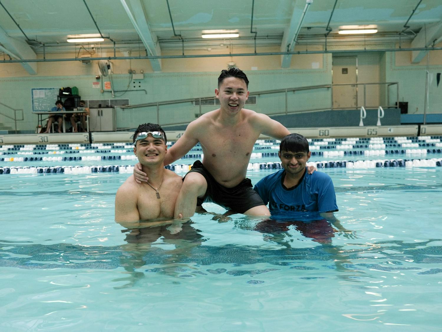UNC sophomore Duy Pham, junior Duc Anh Huynh, and sophomore Rohan Kalelkar pose for a photo at the FWOC Pool Party at the Bowman Gray Indoor Pool on Wednesday, Jan. 11, 2023.