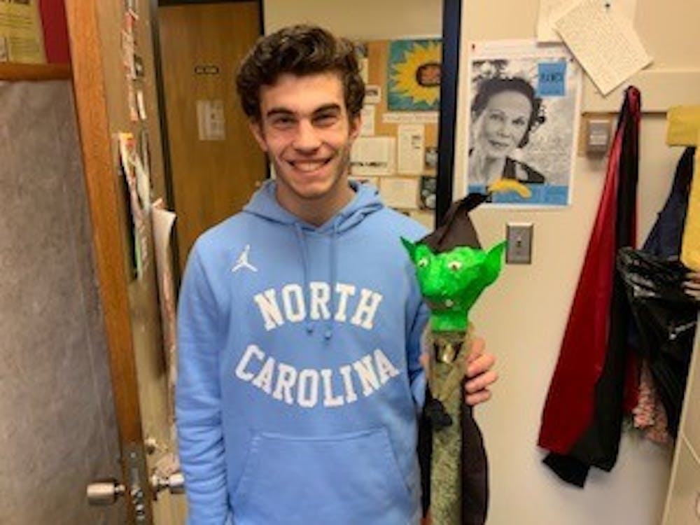 <p>Austin Tumbarello, a student in Marianne Gingher's puppetry class, poses with a magus he made. Gingher teaches a creative writing class about writing for the puppet stage. Photo courtesy of Marianne Gingher.&nbsp;</p>