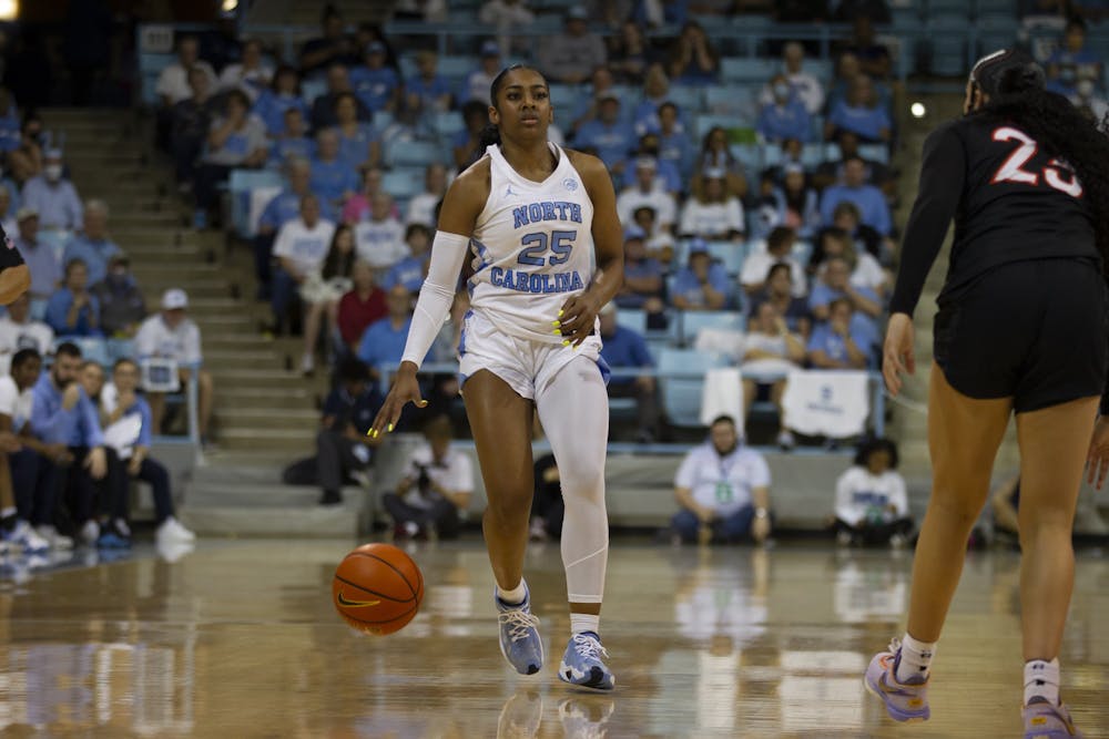 Junior guard Deja Kelly (25) dribbles the ball up court during the women's basketball game against Virginia Tech on Thursday, Feb. 23, 2023, at Carmichael Arena. VT beat UNC 61-59.