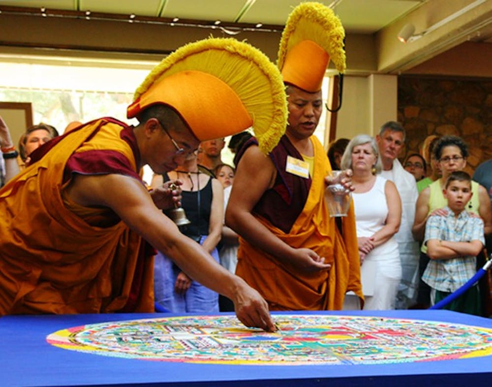 	<p>Tibetan monks from Drepung Gomang Monastery in South India deconstruct their Sacred Sand Mandala during the closing ceremony Monday. </p>