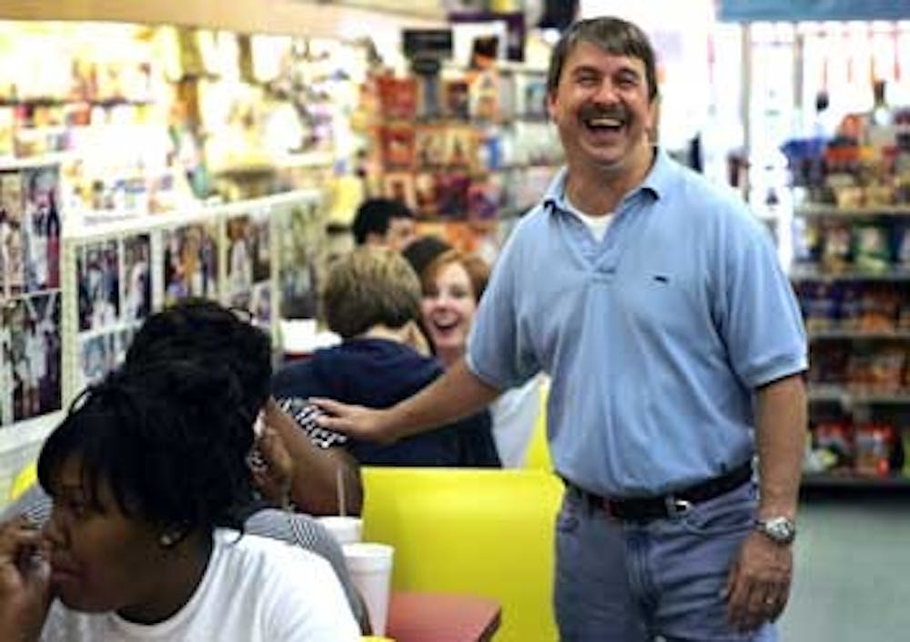 Don Pinney" who manages the restaurant at Sutton?s Drug Store smiles as he talks with a customer at lunch Tuesday. Pinney who expanded the menu to more than 90 items has worked at Sutton?s since he was 14 years old and has been eating there even longer than that.