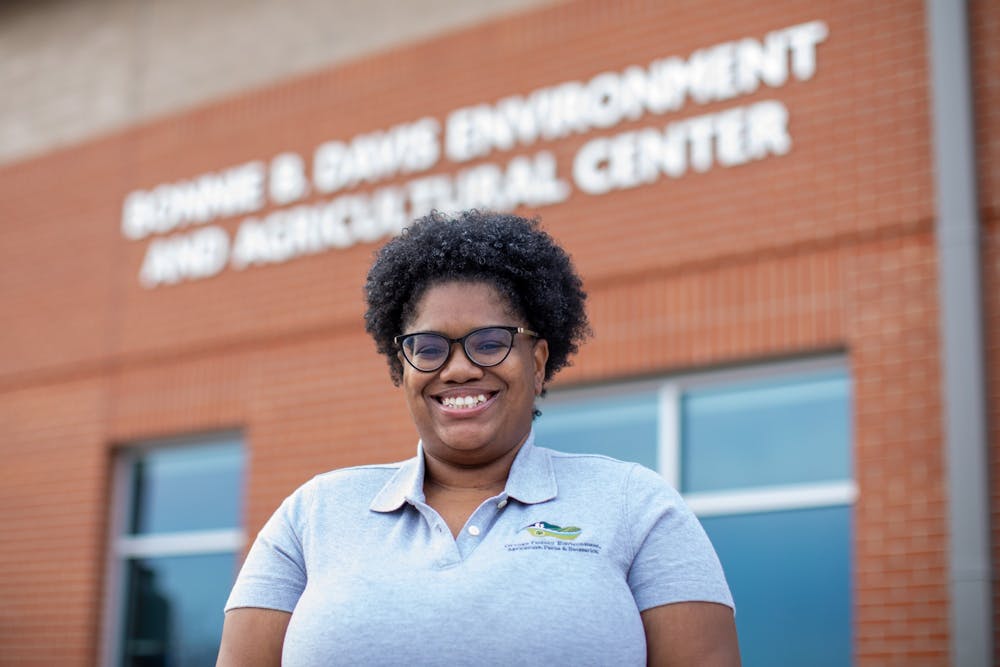 Kalini Allen, an administrative support associate at DEAPR and a coordinator for the Nature of Orange Photo Contest, poses for a portrait outside the Bonnie B. Davis Environment and Agricultural Center in Hillsborough, N.C., on Monday, Feb. 21, 2022.