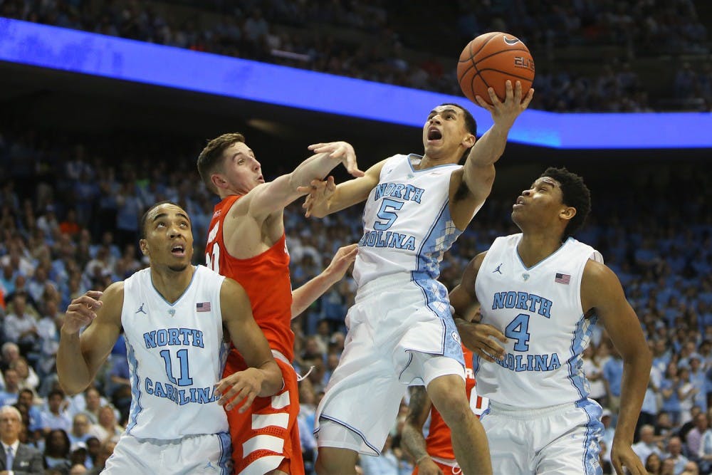 Senior Marcus Paige (5) goes up for a layup during Monday night’s home game.