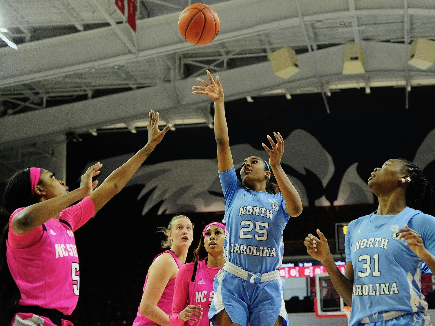 UNC first year guard Deja Kelly (25) takes a shot during a game against NC State in Reynolds Coliseum on Sunday, February 21, 2021. Photo courtesy of Dana Gentry. 