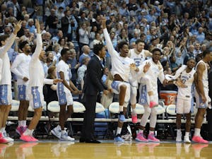 The UNC bench celebrates a basket against Miami on Saturday, Feb. 9, 2019 in the Smith Center. UNC men's basketball defeated Miami 88-85 in overtime.