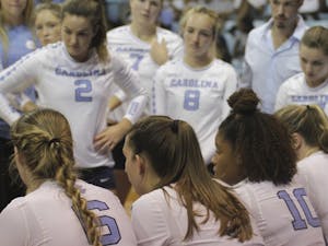The UNC volleyball team gathers during a timeout on Friday night in Carmichael Arena.