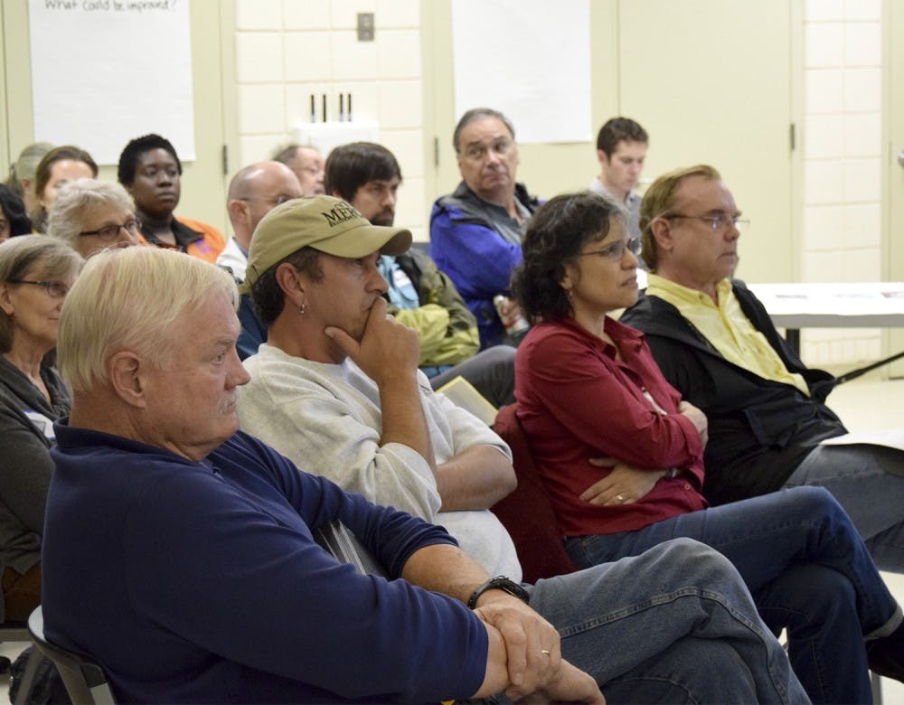 The Town of Chapel Hill held a Open House on October 28th to update residents of Northside on the towns initiatives and partnerships within the Northside Neighborhood. Attendees listen as others in the crowd address organizers about some of the initiatives. 