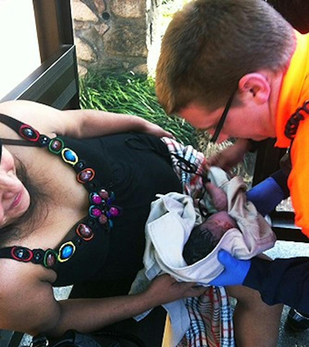 	Paramedics assist a woman who gave birth near Abernethy Hall.

	Photo courtesy of Emily Brewer.