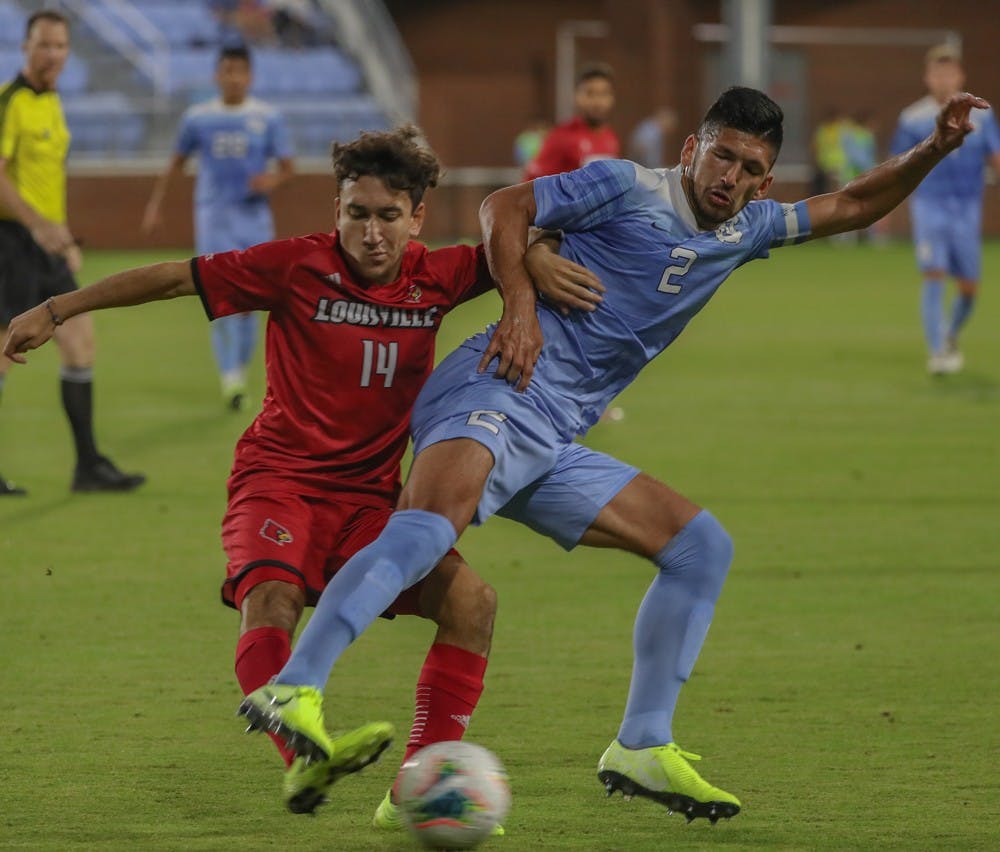 Senior Mauricio Pineda (2) fights for the ball during the game against Louisville on Friday, Oct. 25, 2019. UNC lost to Louisville 0-1. 