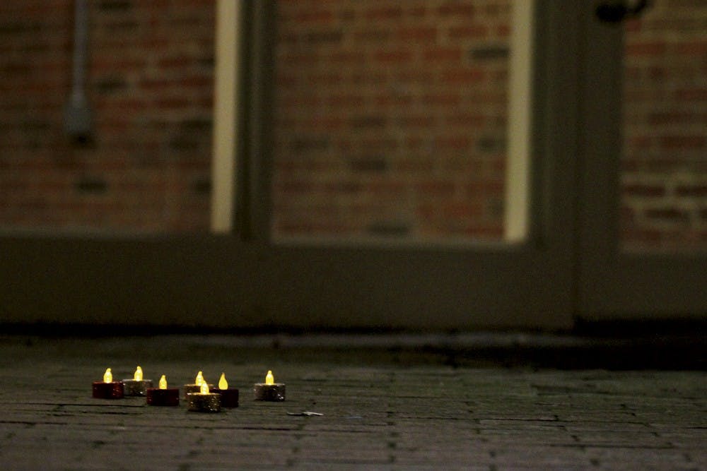 Students placed candles to mark the spot where Demitri Allison fell outside of Morrison Residence Hall on Wednesday.