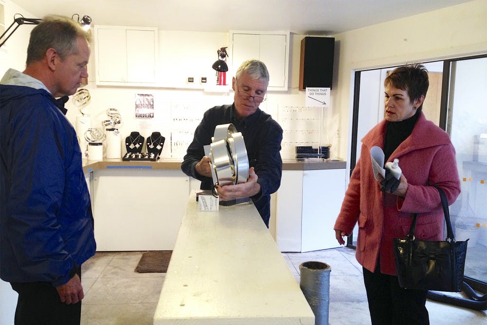 Chapel Hill residents Bill (left) and Kathy Jones complete their purchase of a top-end Dan Murphy sculpture.