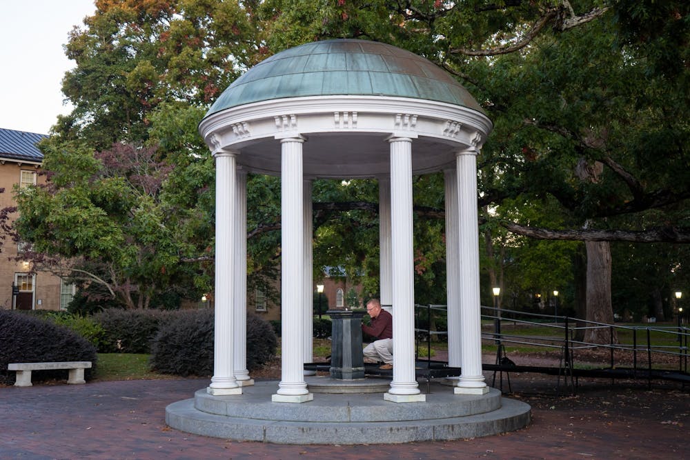 David Catalano from UNC Environmental, Health and Safety collects water samples from the Old Well to test for lead exposure on Thursday, Oct. 20, 2022. Multiple water fountains at UNC have been found to contain unsafe levels of lead.