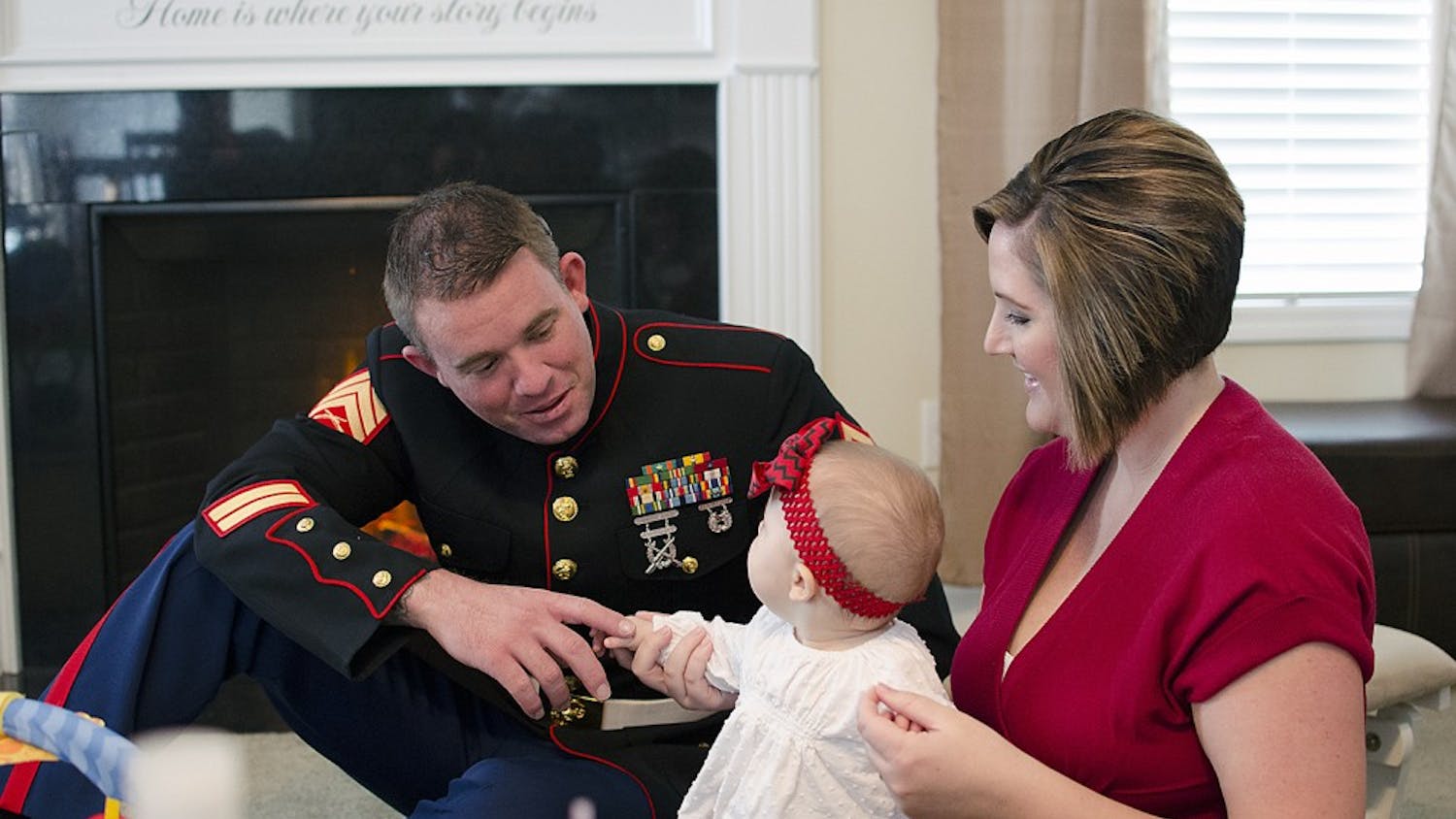 Marine Corps veteran Dac Carpenter and his wife Holly play with their daughter. An implant let Dac Carpenter regain all of the hearing in his left ear.
