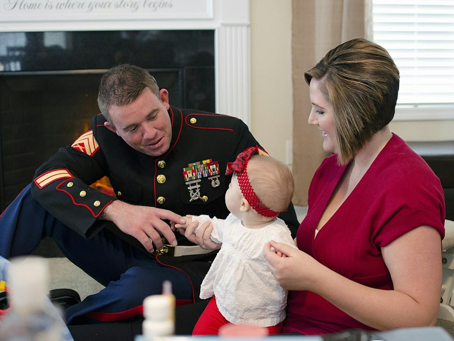 Marine Corps veteran Dac Carpenter and his wife Holly play with their daughter. An implant let Dac Carpenter regain all of the hearing in his left ear.
