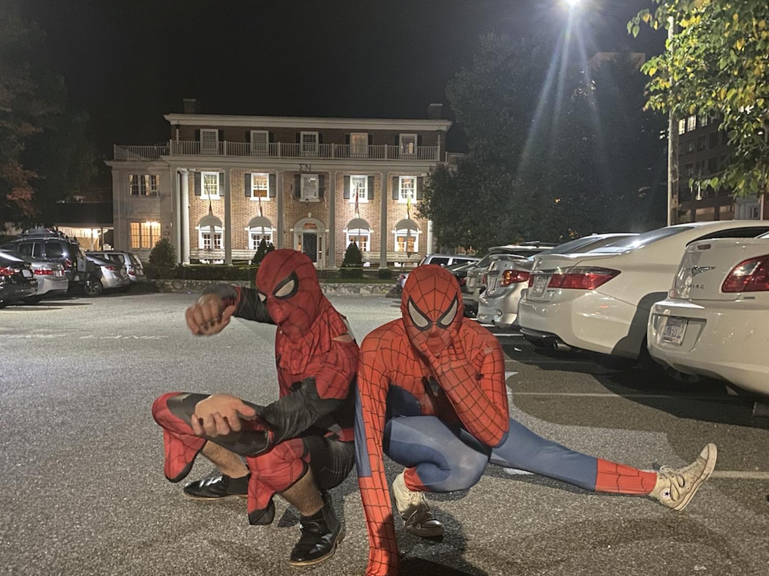 Two of the "Peter Parkers" involved in Tuesday night's Spider-Men event pose pretending to shoot webs out of their arms, as they did in campus libraries. 