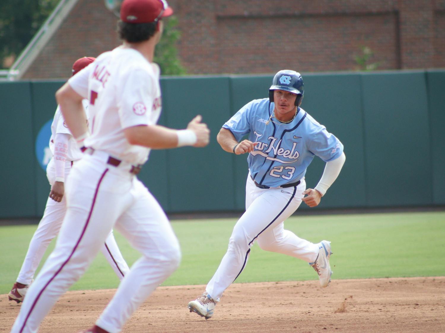 Sophomore designated hitter Alberto Osuna (23) runs towards third base after UNC gets a hit. UNC lost 3-4 against Arkansas at home in the NCAA Super Regionals on Sunday, June 12, 2022.