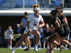 UNC junior midfielder Ally Mastroianni (12) blocks opponents after a pass during the game against Maryland at Dorrance Field on Saturday, Feb. 22, 2020. No 1. UNC won against No 4. Maryland 19-6.